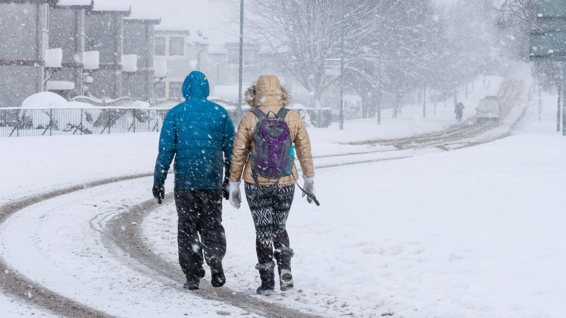 Snowy UK town, couple need ice grips from ICEGRIPPER