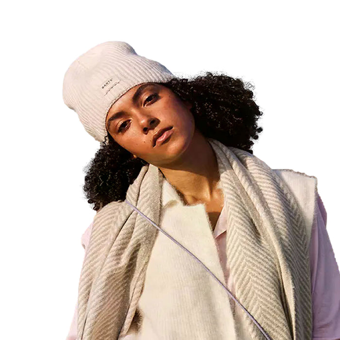 Female model wearing the Barts Darty Beanie in Cream. Demonstrating the soft, ribbed knit.