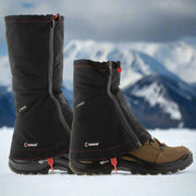Kahtoola LEVAgaiter Mid and Tall shown together worn on Hiking Boots, shown on a snowy mountainous slope. Demonstrating the height difference and typical conditions where they might be used. Buy now at ICEGRIPPER.