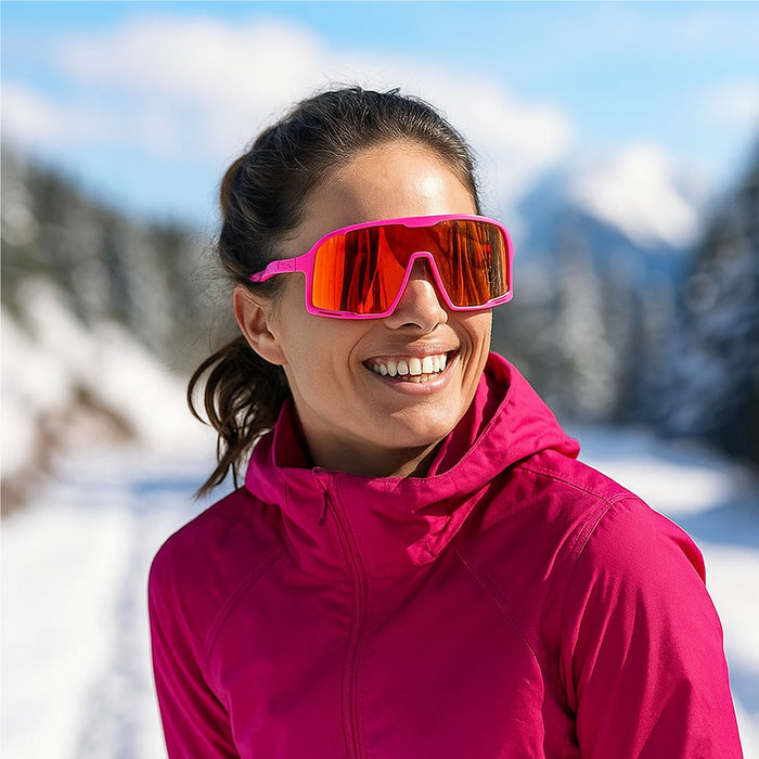 Person wearing pink goggles and jacket in a snowy mountain setting. The Spring Break Campeone is built around Knockaround’s innovative Knockterra performance lens technology, Campeone sunglasses deliver crystal-clear vision, UV400 protection, and impact-resistant durability. Their sleek wraparound design guards against low winter sun and glare reflected from snow and ice, while rubberized adjustable nose grips and flexible non-slip arms ensure a secure, all-day fit during high-energy winter pursuits.
