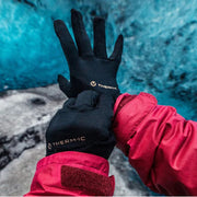 Active Light Tech Gloves in Black. Model wearing them with a red waterproof hiking coat, to demonstrate the Lightweight, Tactile, Multi-Activity Gloves for All-Season Comfort. Buy now at ICEGRIPPER.