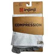 Pack shot. Injinji Compression Over the Calf Toe Socks. Buy now at ICEGRIPPER. A pair of light gray ribbed compression toe socks folded inside a brown kraft paper blister card by injinji, with the brand name and 'PERFORMANCE COMPRESSION' printed on the packaging.