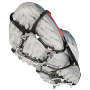 Kahtoola Microspikes Ghost Footwear Traction in an elevated walking positon, showing the underfoot TPU matrix and 12, 9mm stanless steel spikes and articulated design, which helps the Ghost to shed snow and debris, helping to give solid traction on snow and ice.
