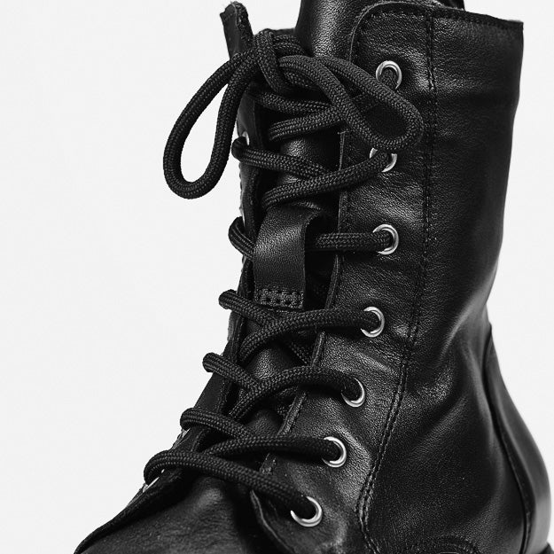 Close-up of the black leather upper, metal eyelets and front lacing on Ilves Särna.