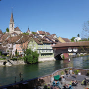 The picturesque Swiss town of Baden. Known for its thermal baths and historic spa district located at the foothills of the Jura mountains. This image shows the famous wooden bridge over the river on a clear sunny day.