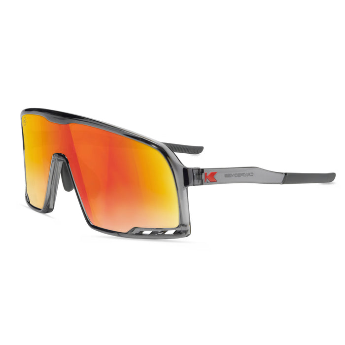 Sunglasses with orange reflective lenses and gray frame on a white background. Now available from ICEGRIPPER, the Knockaround Campeone Magma combines advanced performance technology with rugged outdoor style — ideal for trail runners, winter hikers, mountain trekkers, and polar explorers who demand comfort and clarity in challenging light conditions. Buy now at ICEGRIPPER.