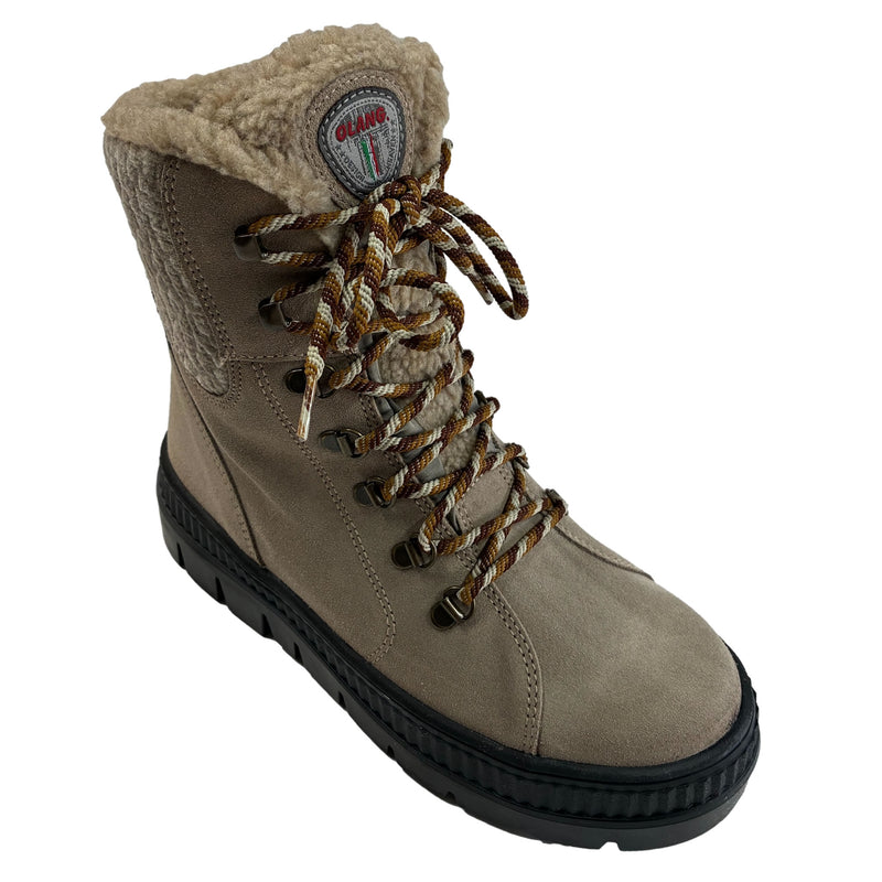 A single mid-calf lace-up boot in clay coloured suede with a plush beige sherpa lining, brown and beige laces, and a black sole, shown on a plain white background. Olang Praga TEX OC Clay – Women's Winter Ice Grip Boots.