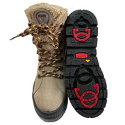 A pair of beige suede boots with a shearling-style collar, brown and tan laces, and a black treaded sole featuring OCSystem on/off ice grips. One boot is shown from the side/front and the other from the sole/top view, set against a plain white background. Olang Praga TEX OC Clay – Women's Winter Ice Grip Boots