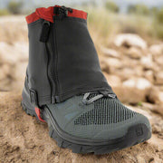 Kahtoola RENAgaiter shown on a trail shoe sat on a sandy trail. Demonstrating the type of conditions in which the RENAgaiter would be used. Buy now at ICEGRIPPER.