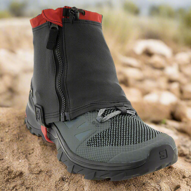 Kahtoola RENAgaiter shown on a trail shoe sat on a sandy trail. Demonstrating the type of conditions in which the RENAgaiter would be used. Buy now at ICEGRIPPER.