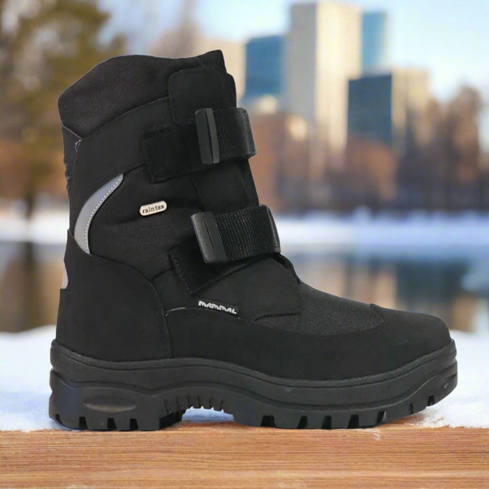 Mammal Sorex 3 OC Black Mens Winter Boot on a snowy ledge, with a winter cityscape in the background.